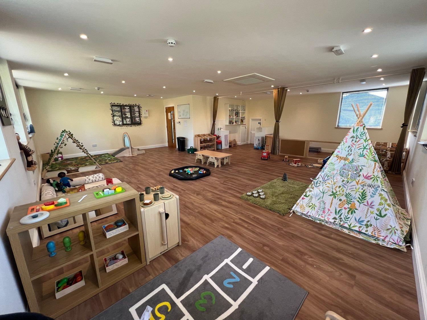 A spacious playroom with varied areas for independent exploration