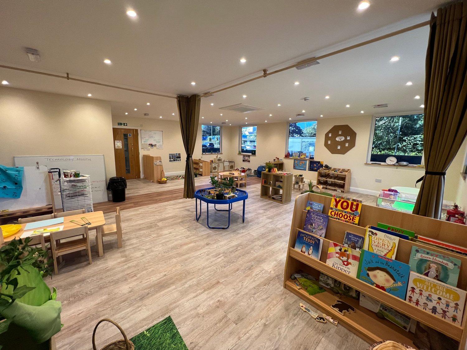 The preschool room with books and activity tables